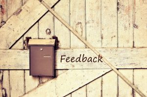 image of mailbox on barn door titled "feedback"