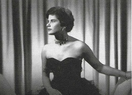 Vintage photograph of woman in black dress sitting down.