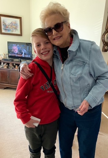 Young boy and his grandma with arms around each other.