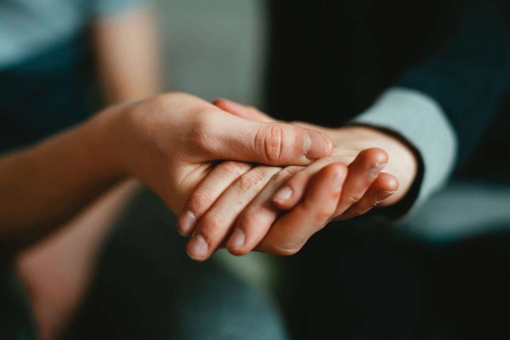 A person holding another's hand.