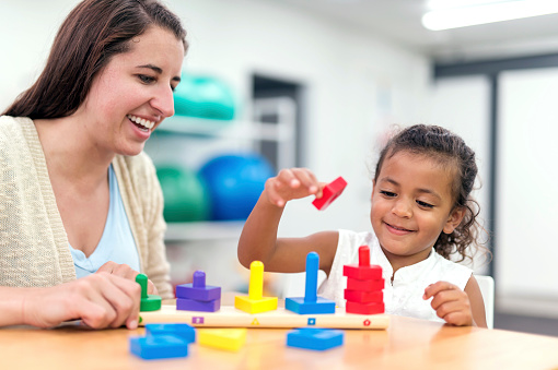 Young ethnic girl doing an exercise in a therapy session