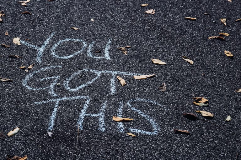 "you got this" written in white chalk on asphalt