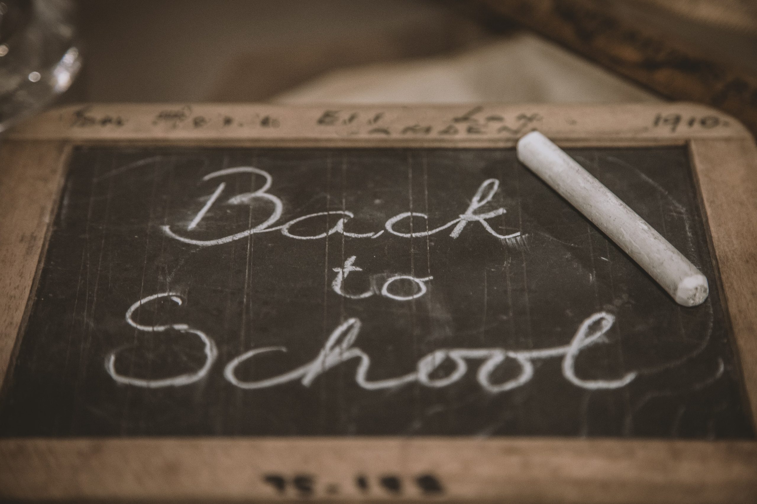 Back to school written on a black chalk board with white chalk